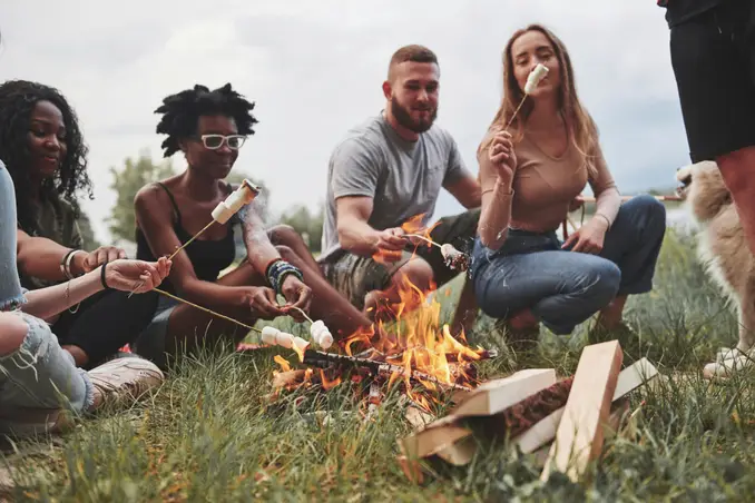 A group of young people roast marshmallows, having fun sober!