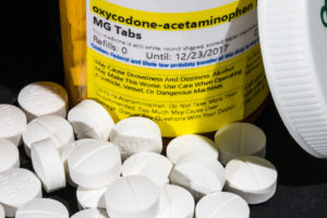 Prescription Opioid Abuse | At-Home Detox | Find Addiction Rehabs | Oxycodone bottle with tablets scattered about