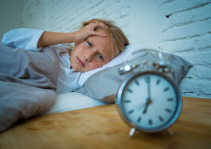 At Home Detox is Risky and Dangerous | Find Addiction Rehabs | Woman struggling to sleep or wake up due to addiction