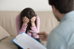 Relapse Triggers and Patterns of Thinking | Find Addiction Rehabs | Woman in therapy coping with addiction triggers