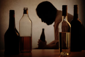 LGBT Alcohol Abuse | Find Addiction Rehabs | Man drinking alone coping with mental illness