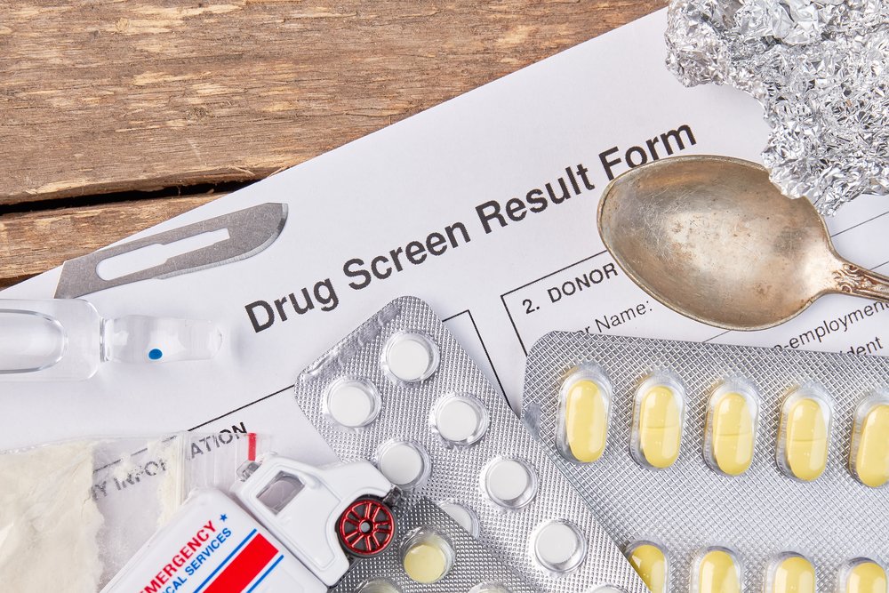 Drug Test - Photo of a "Drug Screen Result Form" with 3 pill packs, a spoon and some crushed up aluminum foil.