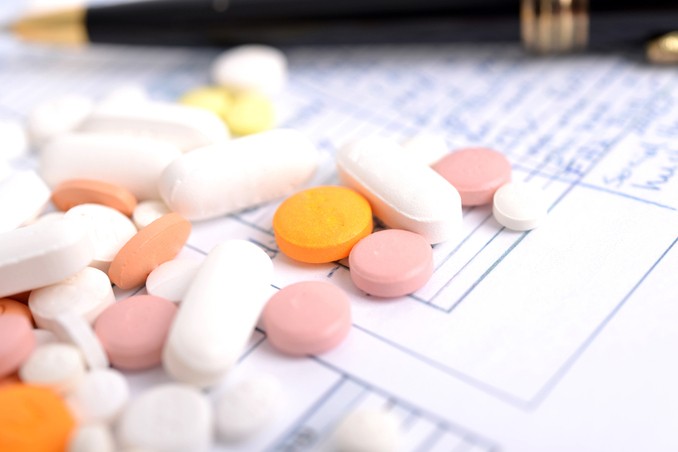 Anti-depressant pills strewn across a prescribing pad