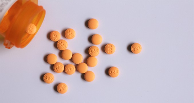 Cyclobenzaprine prescription bottle spilling out pills