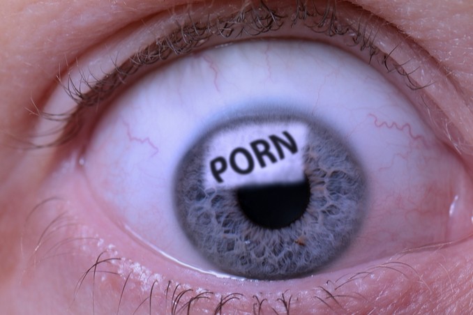 Image of eye reflecting the word 'porn' close-up