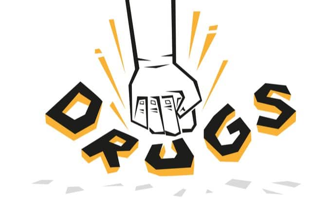 Stylized fist smashing the word 'Drugs' to illustrate substance abuse prevention