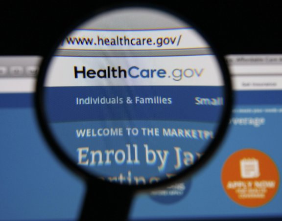 Healthcare.gov shown on a screen through a magnifying glass, to show the importance of using the Marketplace for addiction treatment