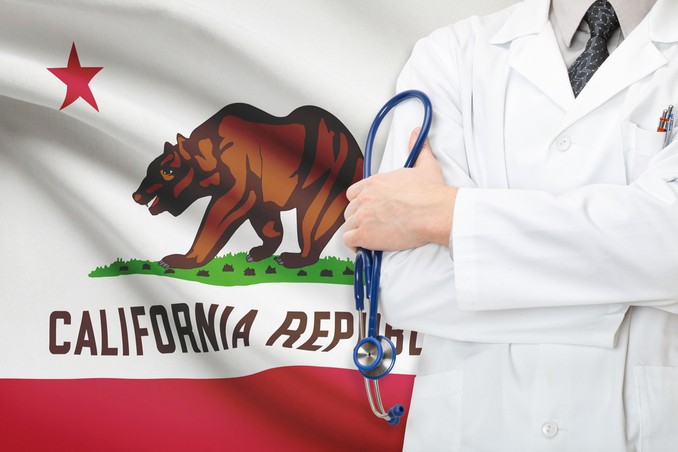 Doctor stands in front of the state flag of California, to indicate the premier drug and alcohol rehab centers in the state