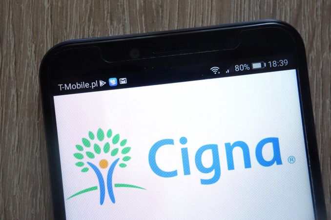 cell phone with Cigna logo shown, to illustrate rehabs that accept Cigna insurance concept