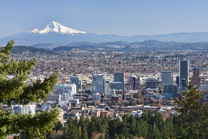 The city of Portland Oregon stretches out under Mount Hood, a scenic and beautiful location for addiction treatment with a thriving addiction recovery community