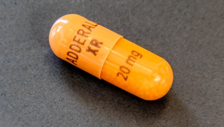 A close-up of Adderall XR pill, shows the concept of Adderall addiction