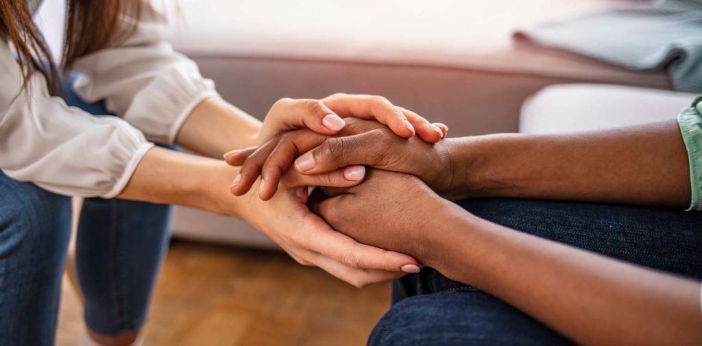 The Power of Personal Messages on Addiction, as shown by hands embracing during peer support groups
