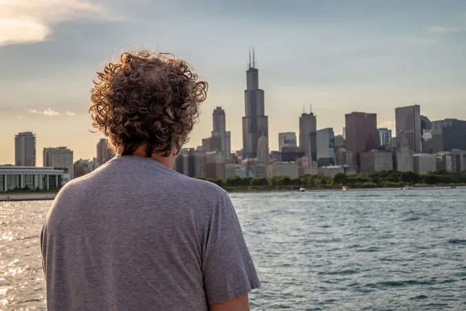 Addiction aftercare in Michigan, man looks at skyline, seeking