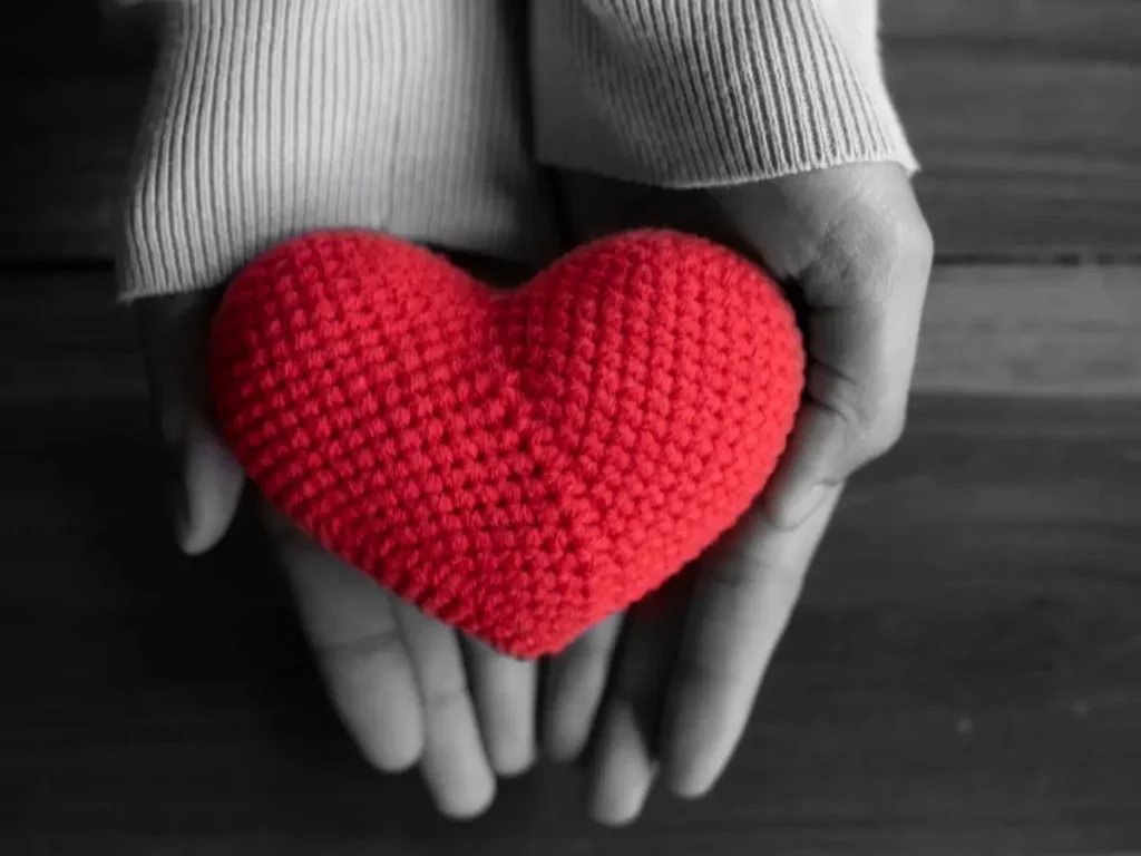 Bright red heart held in hands shows the concept of rehabs that accept Ambetter insurance