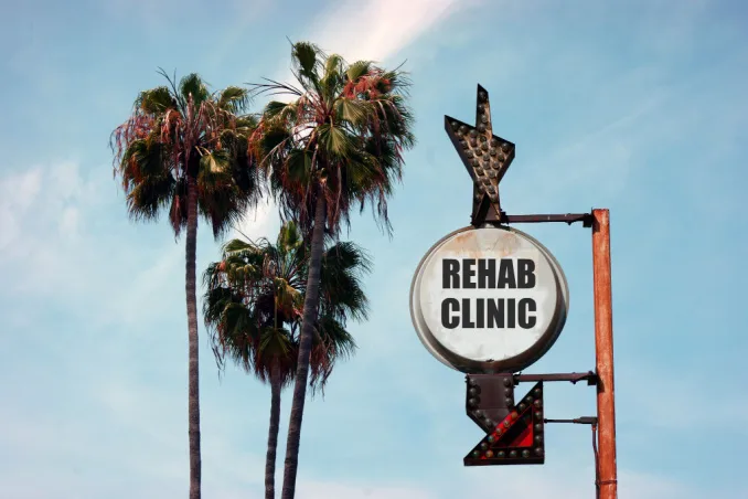 An old 'Rehab Clinic' sign shows the concept of best rehab centers in California