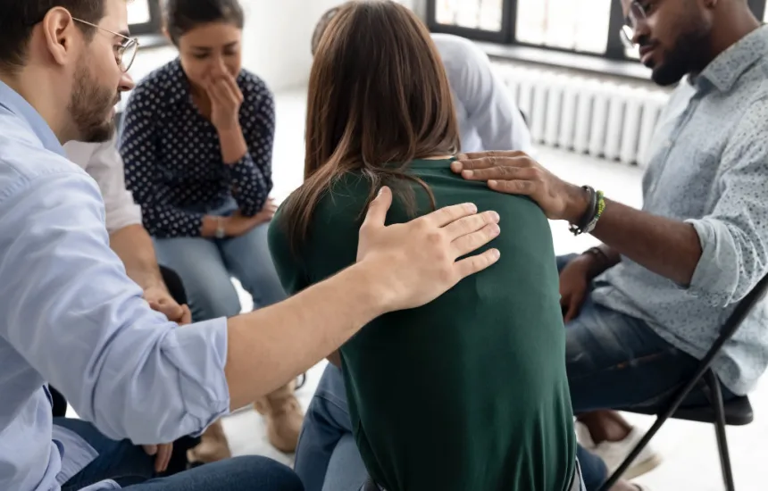 Woman being comforted in group therapy shows benefits of medical detox for methadone