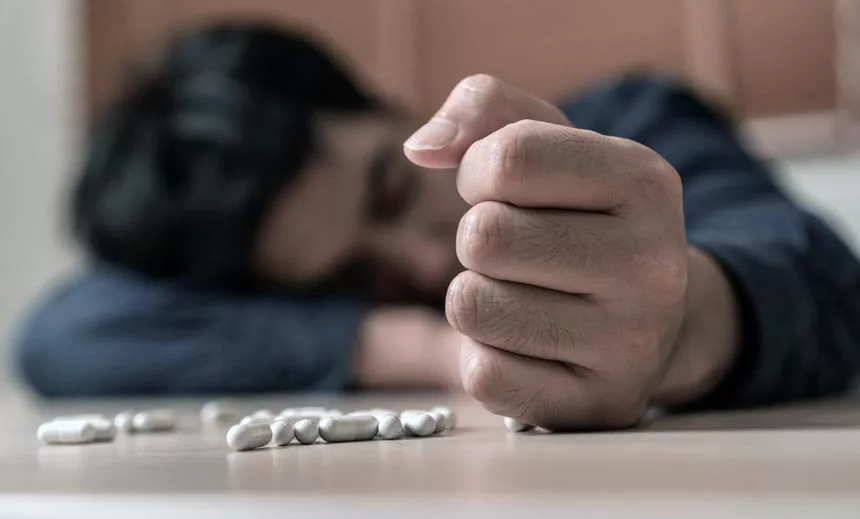 Opiate Addicted Man Holding Drugs