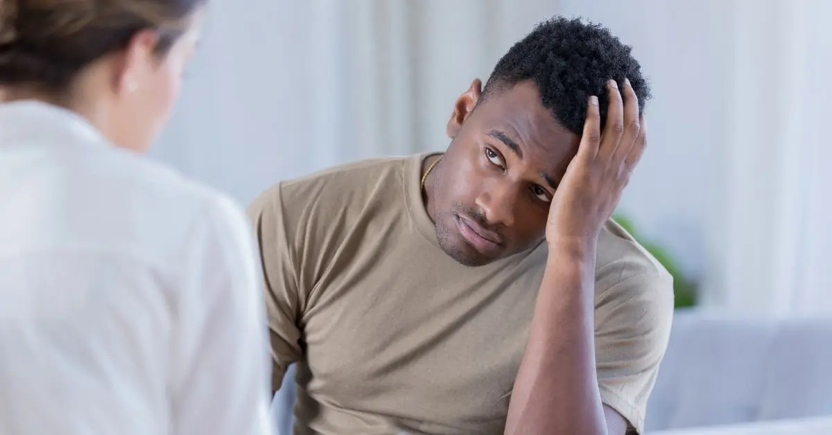 A man looks at his clinician wondering about the confidentiality of his mental health treatment in the military